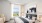 Modern furnished bedroom at Watermark Seaport featuring views of Boston Harbor.